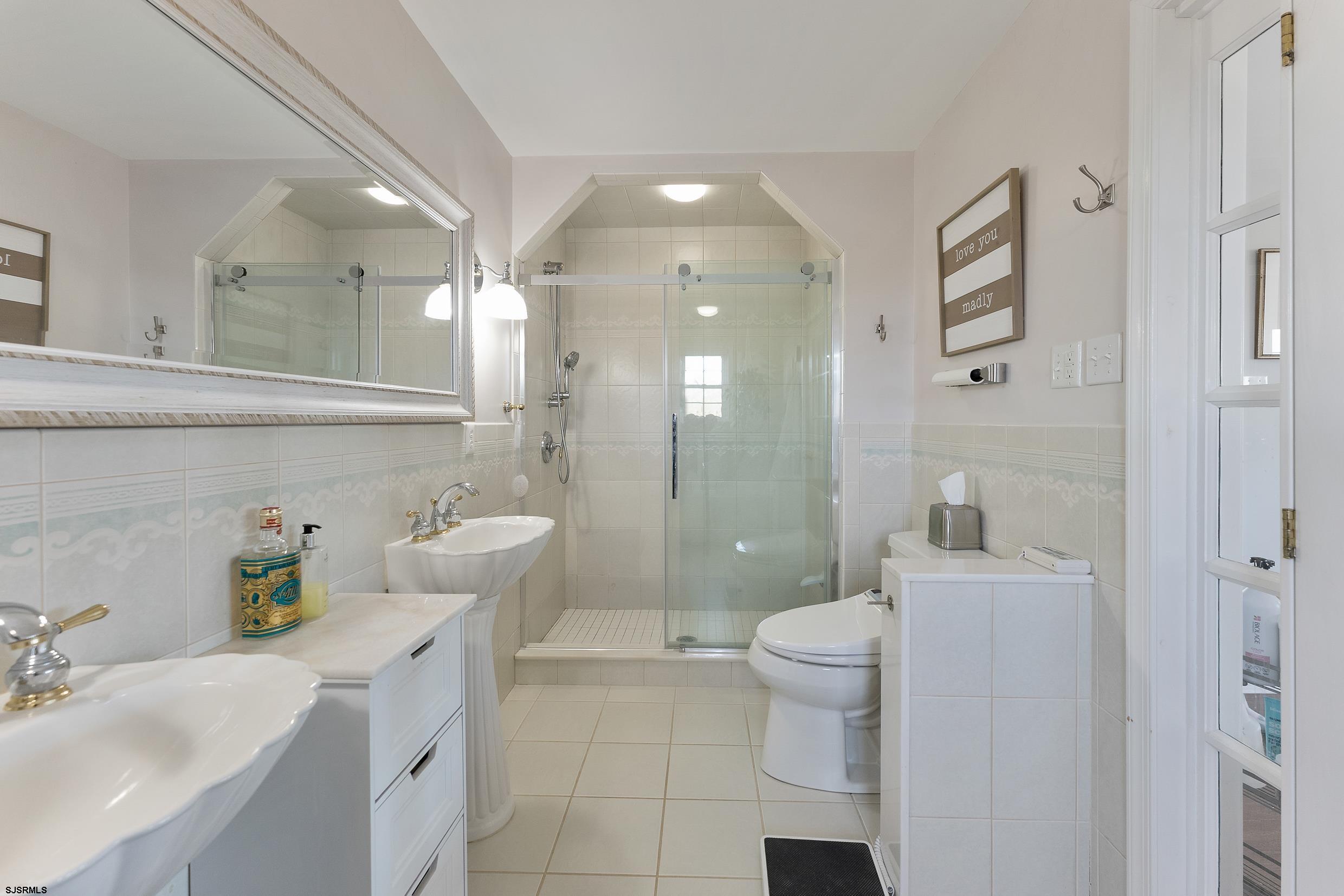 102 Broadway, Unit 2 Somers Point, NJ 08244 - Photo 52 of 98 a bathroom with a sink a toilet and shower