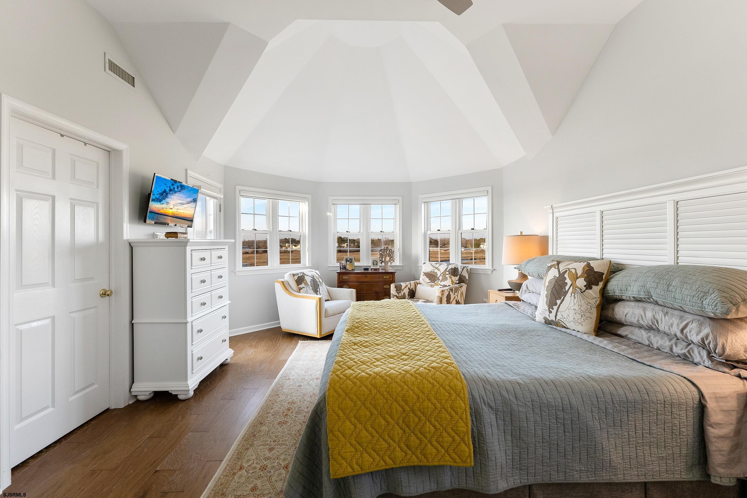 102 Broadway, Unit 2 Somers Point, NJ 08244 - Photo 53 of 98 a spacious bedroom with a bed and wooden floor