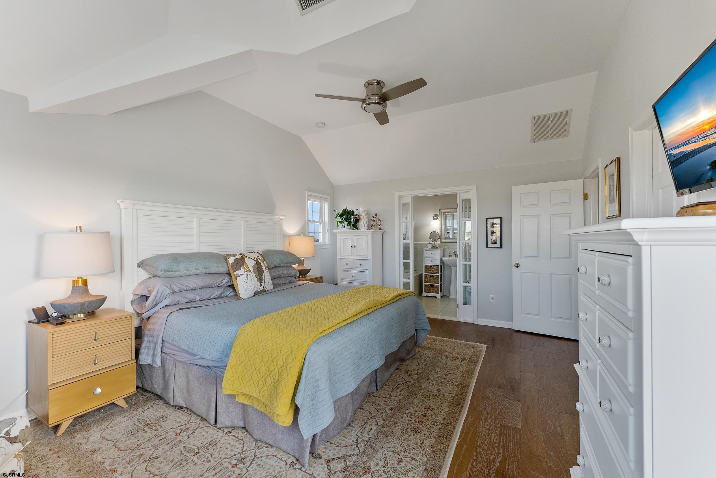 102 Broadway, Unit 2 Somers Point, NJ 08244 - Photo 55 of 98 a spacious bedroom with a bed and a flat tv screen