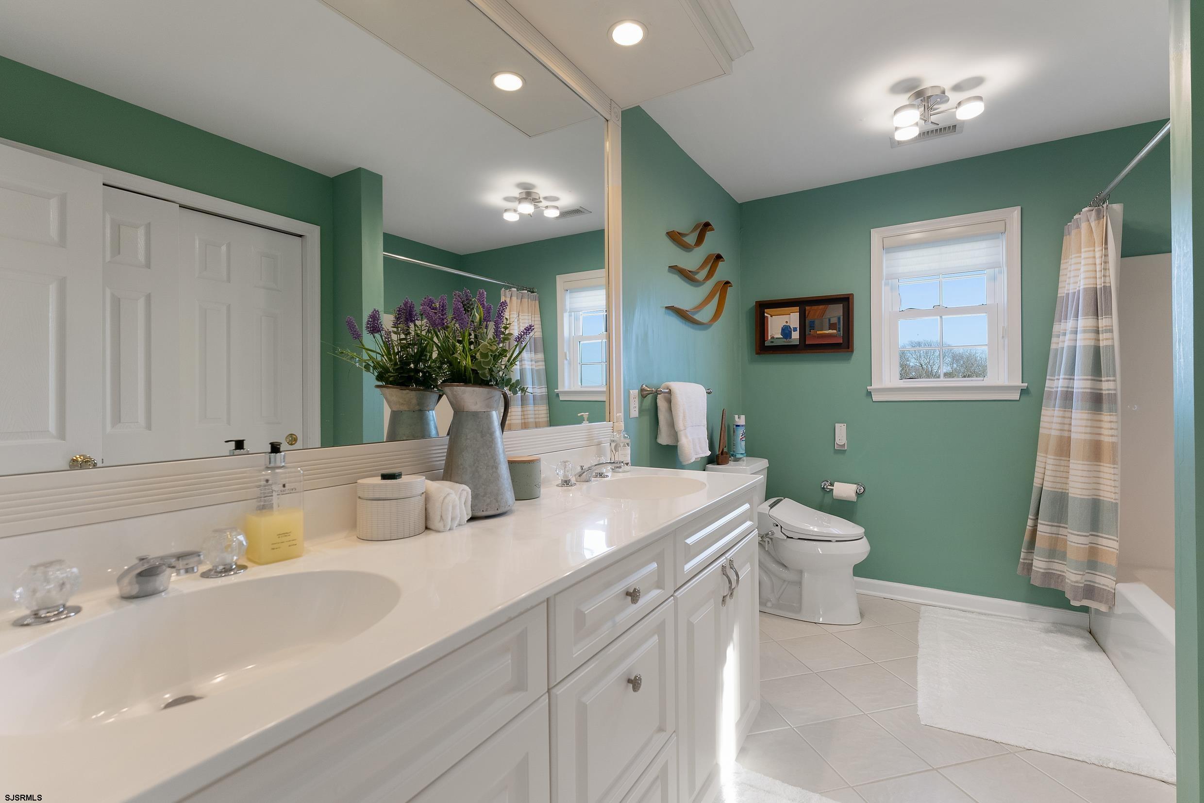102 Broadway, Unit 2 Somers Point, NJ 08244 - Photo 62 of 98 a bathroom with a sink double vanity and a toilet