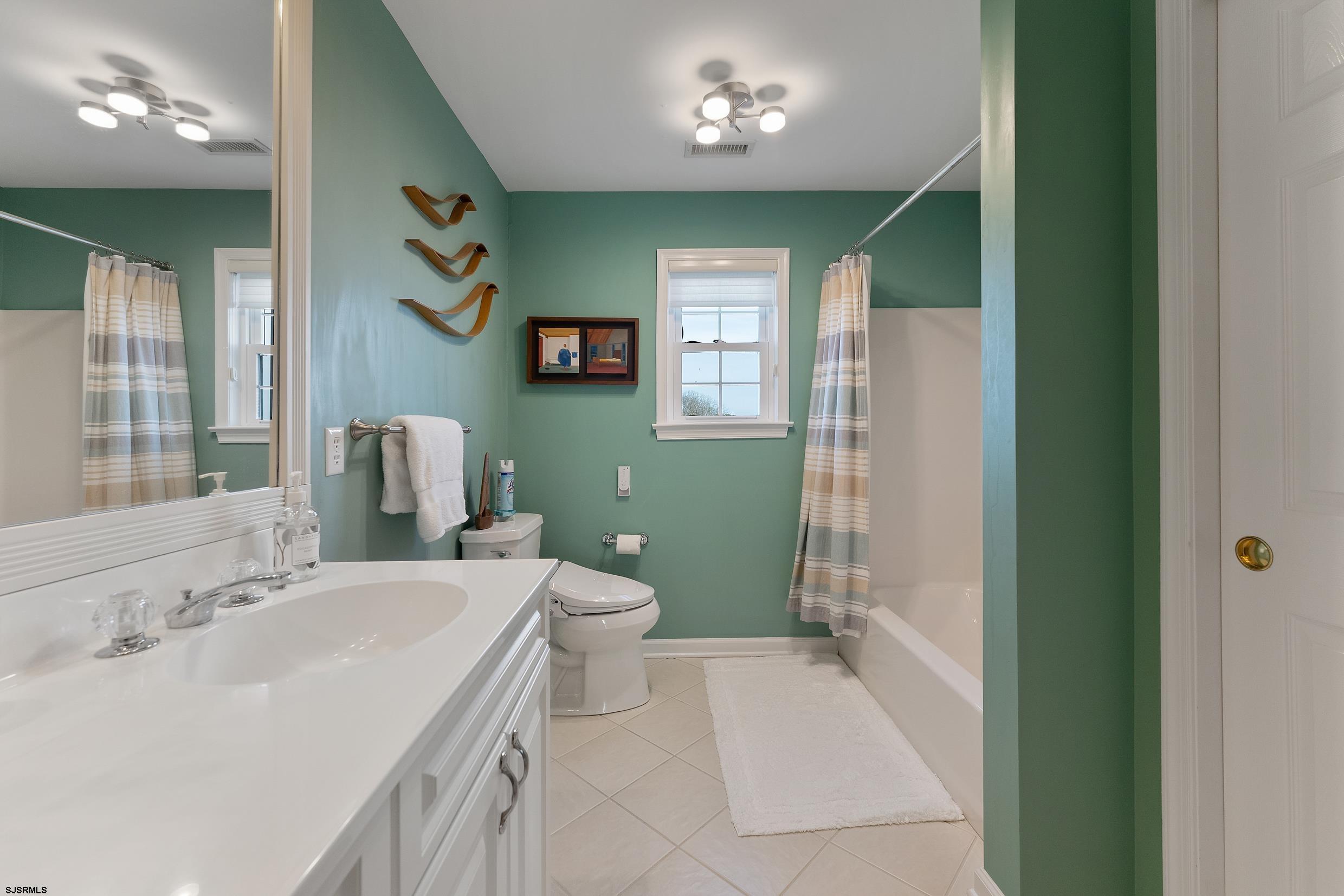 102 Broadway, Unit 2 Somers Point, NJ 08244 - Photo 63 of 98 a bathroom with a sink a toilet and shower