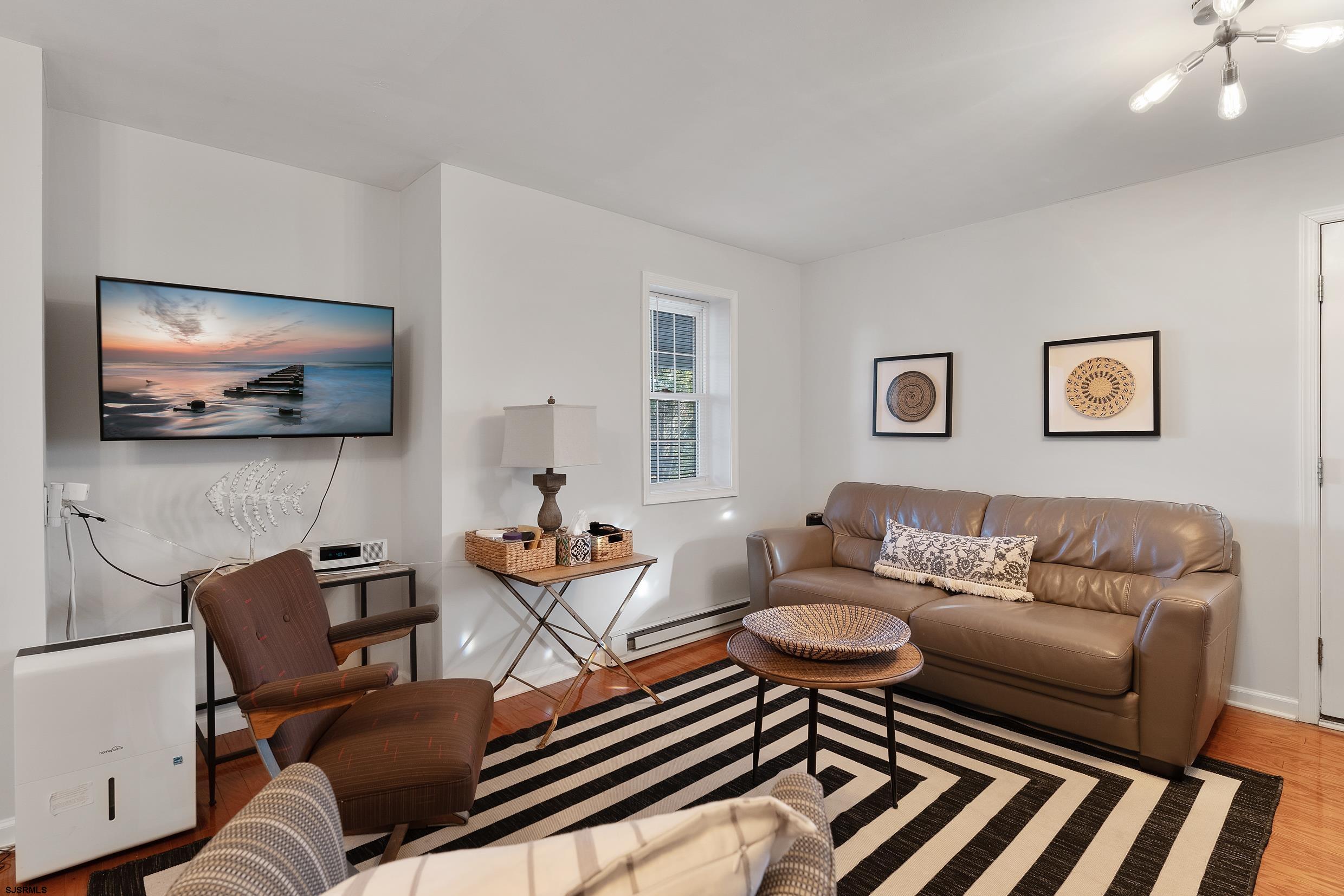 102 Broadway, Unit 2 Somers Point, NJ 08244 - Photo 8 of 98 a living room with furniture and a flat screen tv