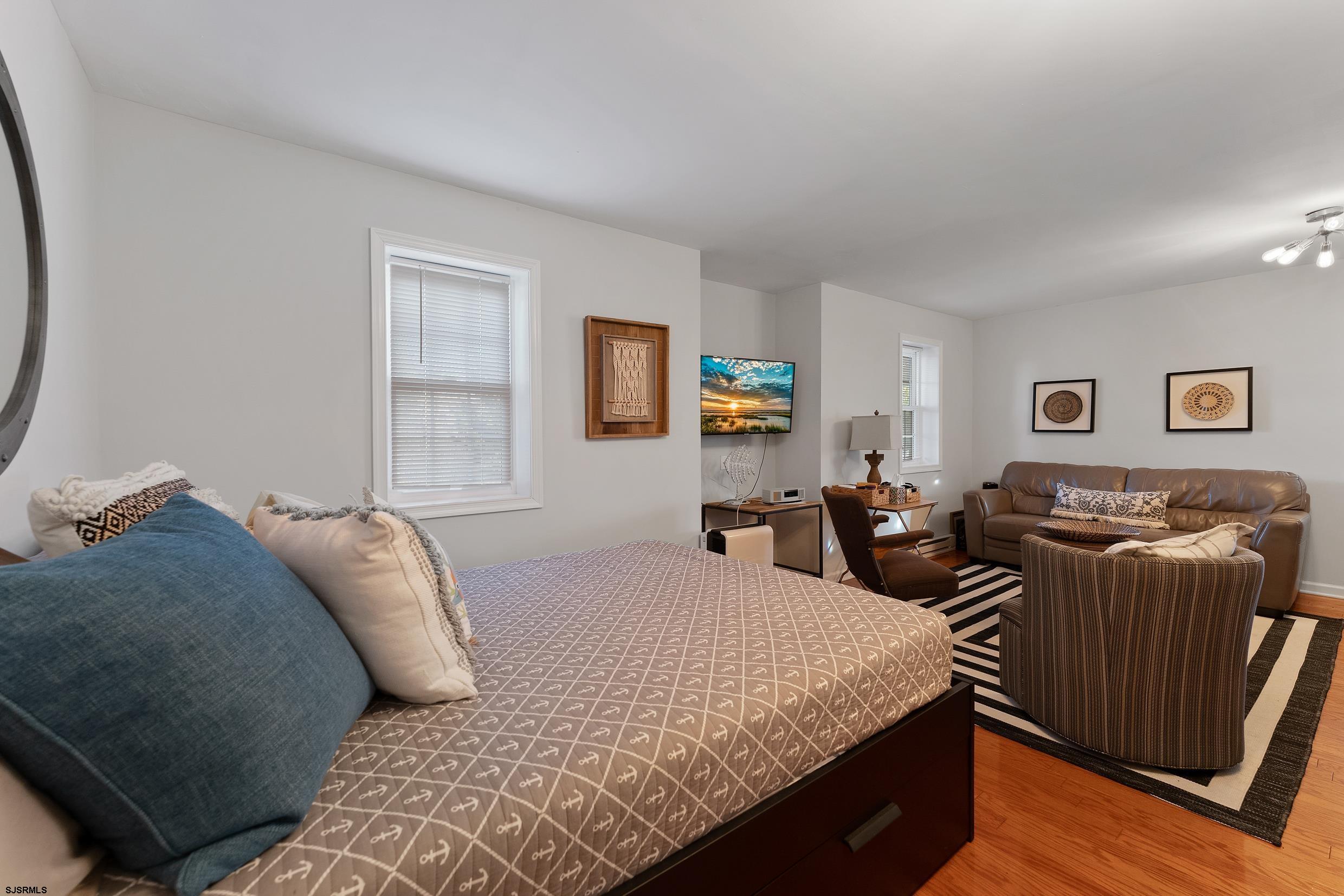 102 Broadway, Unit 2 Somers Point, NJ 08244 - Photo 9 of 98 a bed room with a bed and a couch