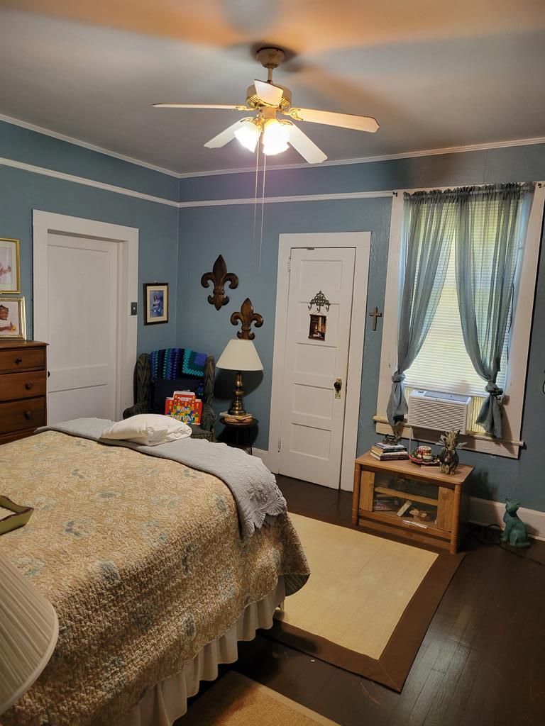 2512 19th Avenue Columbus, GA 31901 - Photo 6 of 9 a bedroom with a bed and a chandelier