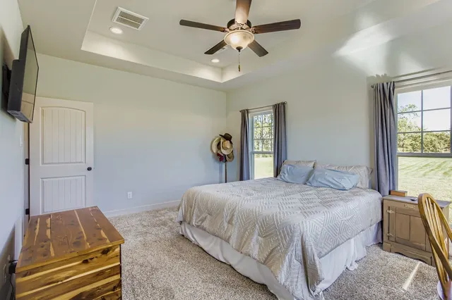 a bedroom with a bed and a chandelier