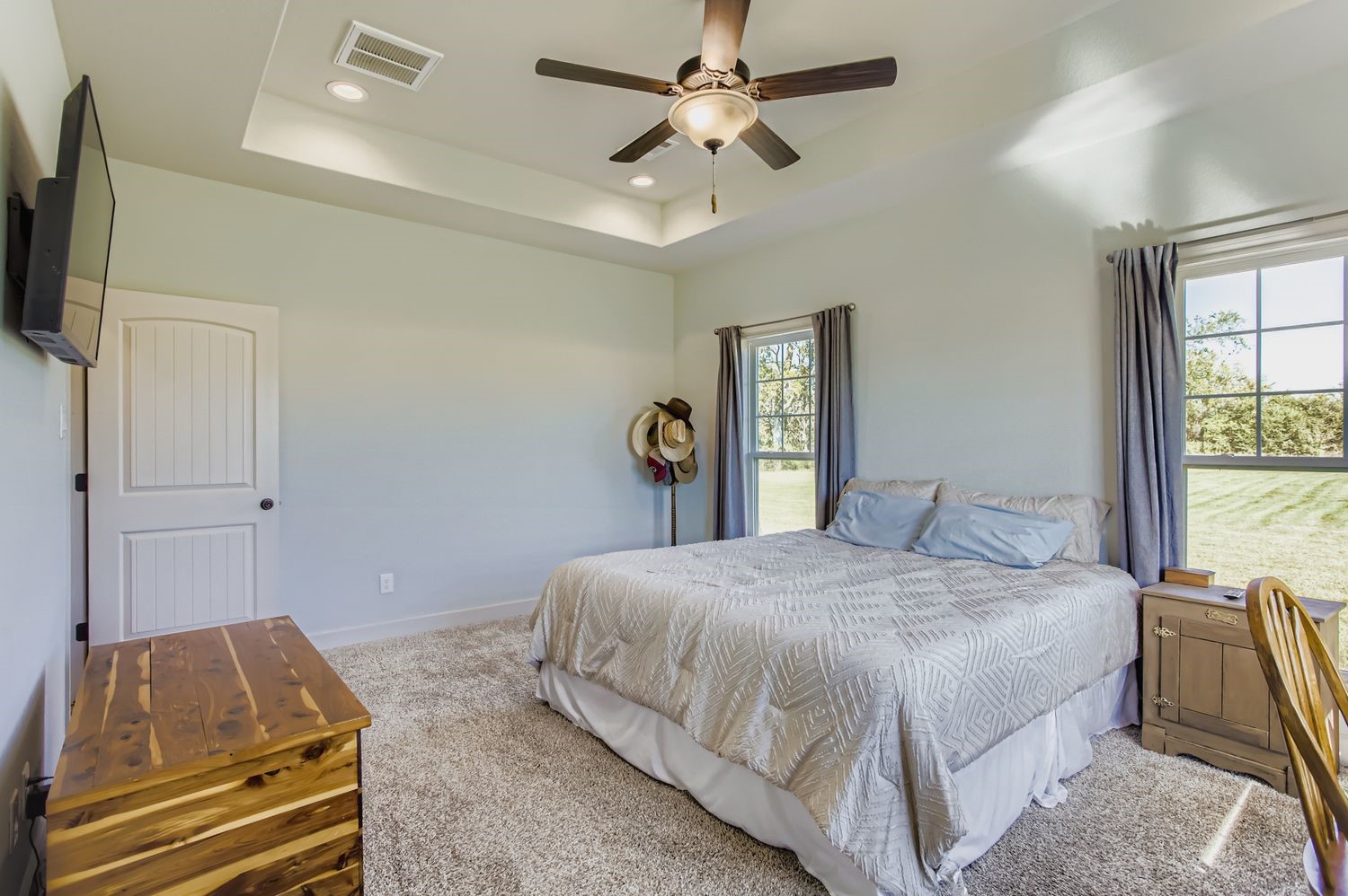 32123 Howell Road Waller, TX 77484 - Photo 16 of 28 a bedroom with a bed and a chandelier