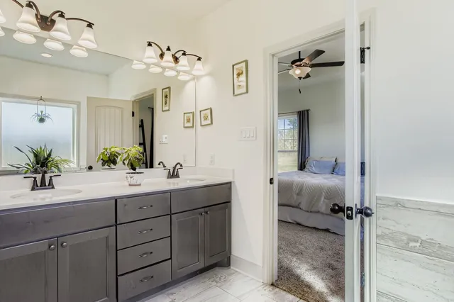 a bathroom with a double vanity sink mirror and