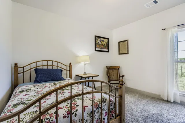 a bedroom with bed and a window