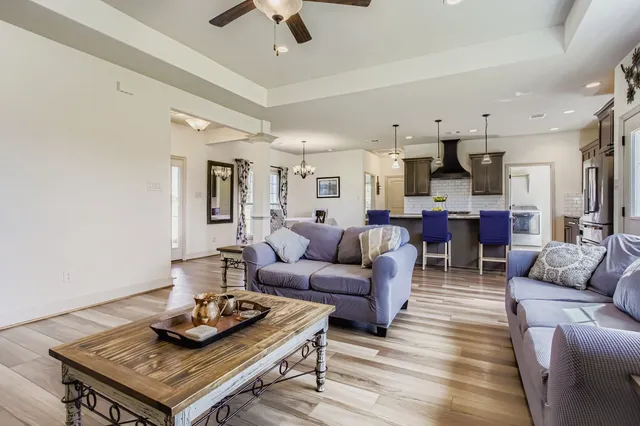 a living room with furniture kitchen view and a table