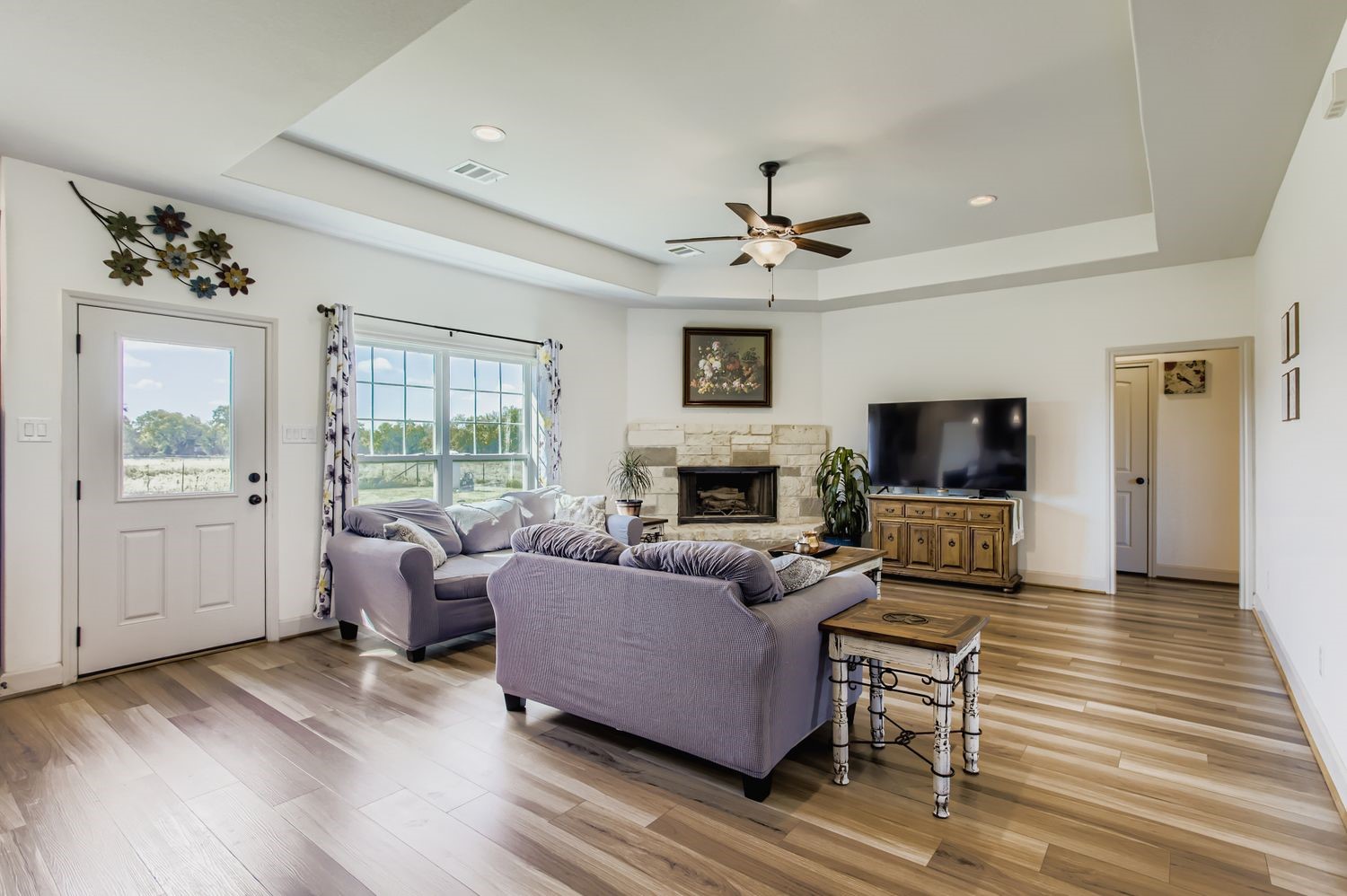32123 Howell Road Waller, TX 77484 - Photo 9 of 28 a living room with furniture a flat screen tv and a fireplace