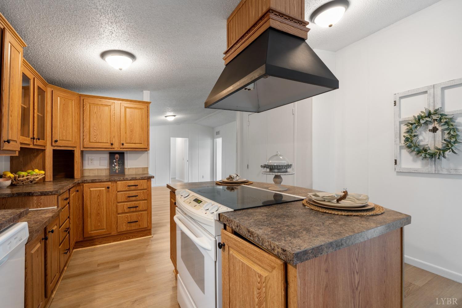 128 Douglas Drive Dry Fork, VA 24549 - Photo 12 of 45 a kitchen with stainless steel appliances granite countertop a sink a stove and a wooden cabinets