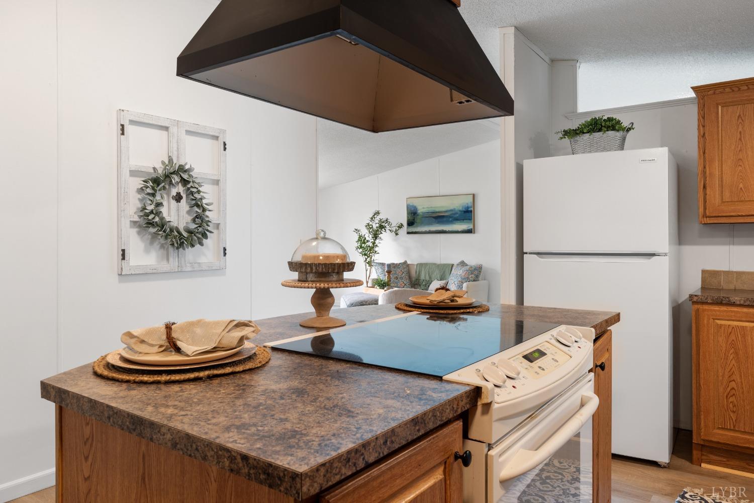 128 Douglas Drive Dry Fork, VA 24549 - Photo 14 of 45 a living room with dining table and a refrigerator