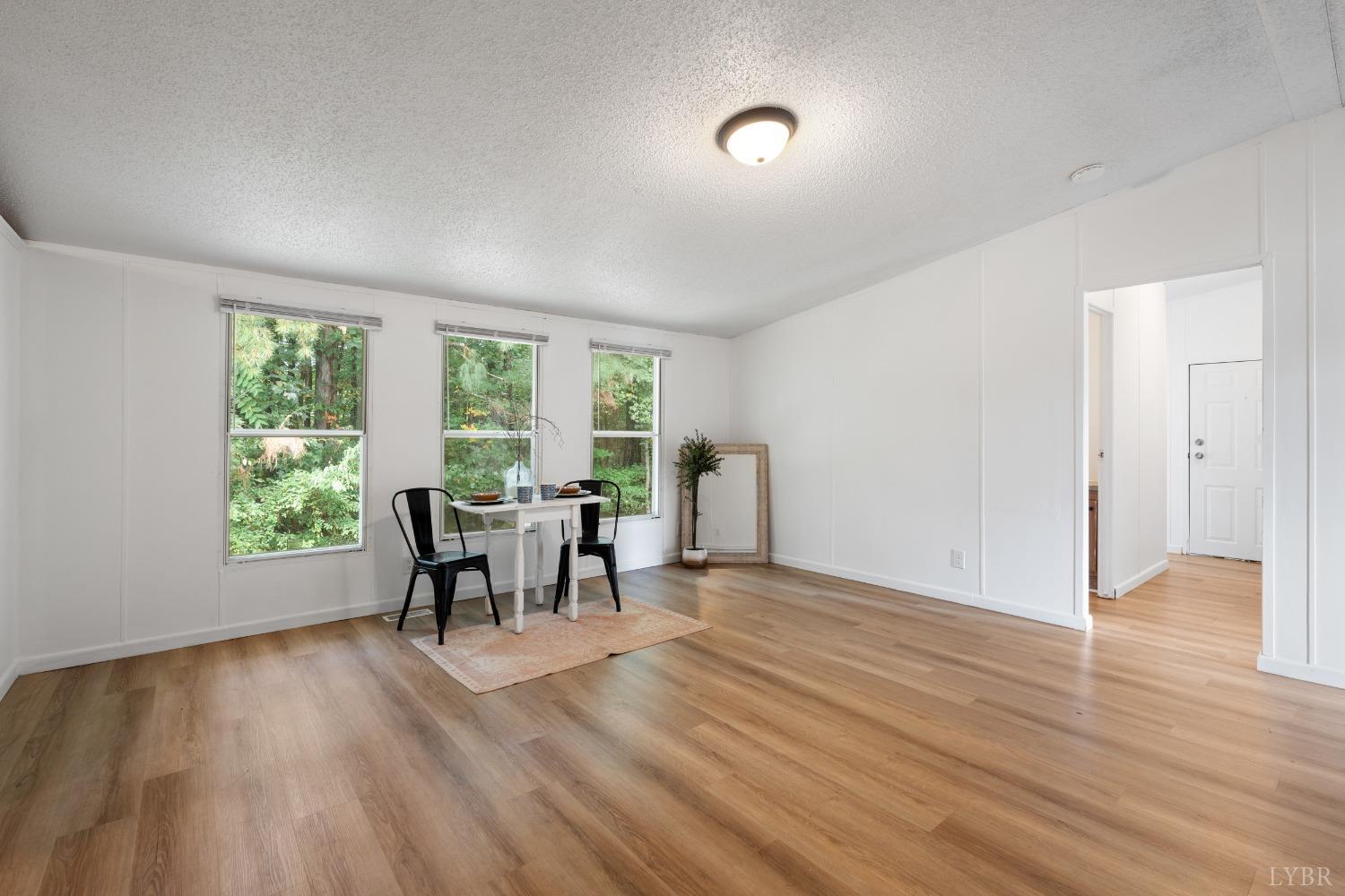 128 Douglas Drive Dry Fork, VA 24549 - Photo 15 of 45 wooden floor in an empty room with a window