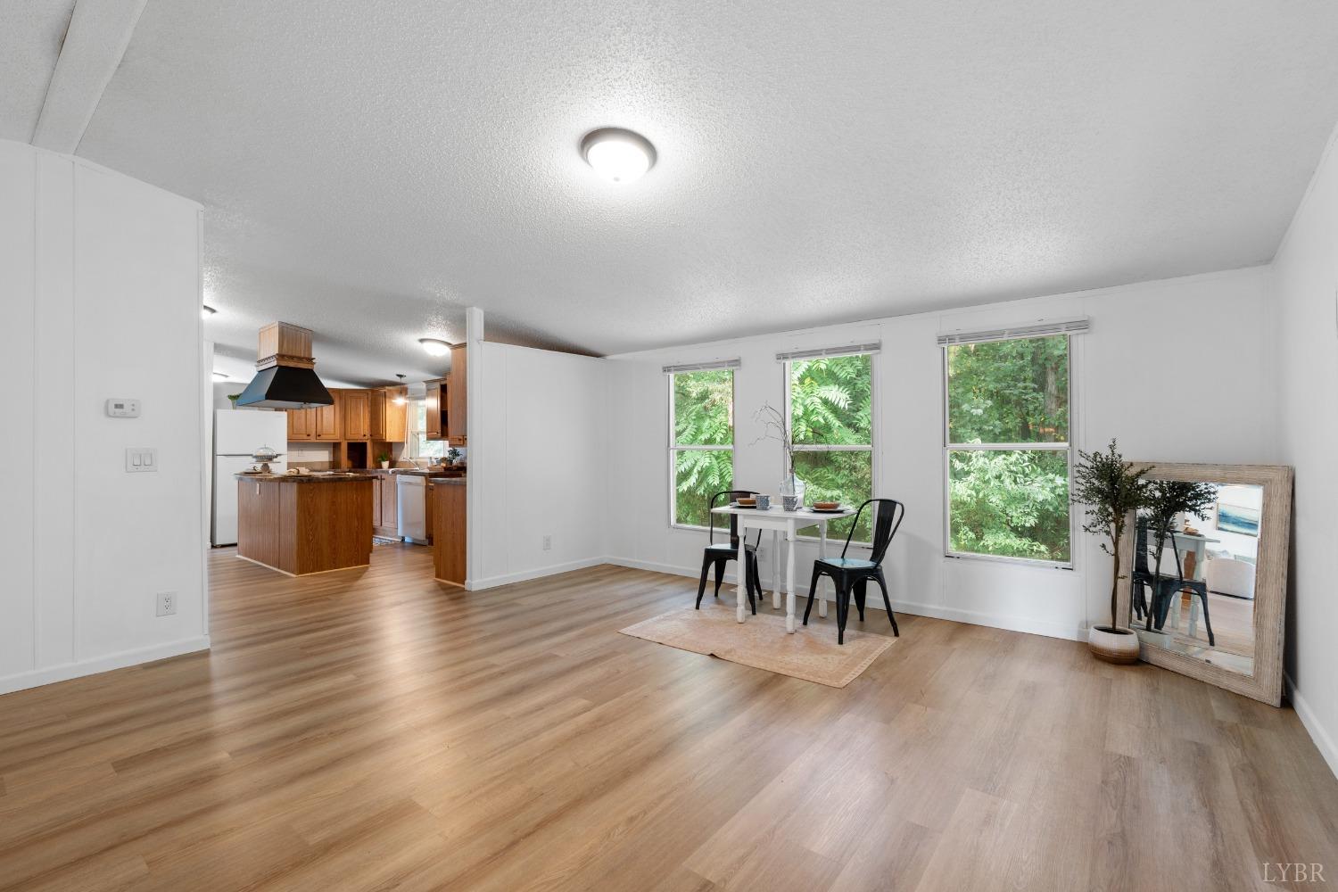 128 Douglas Drive Dry Fork, VA 24549 - Photo 16 of 45 a view of a dining room with furniture window and wooden floor