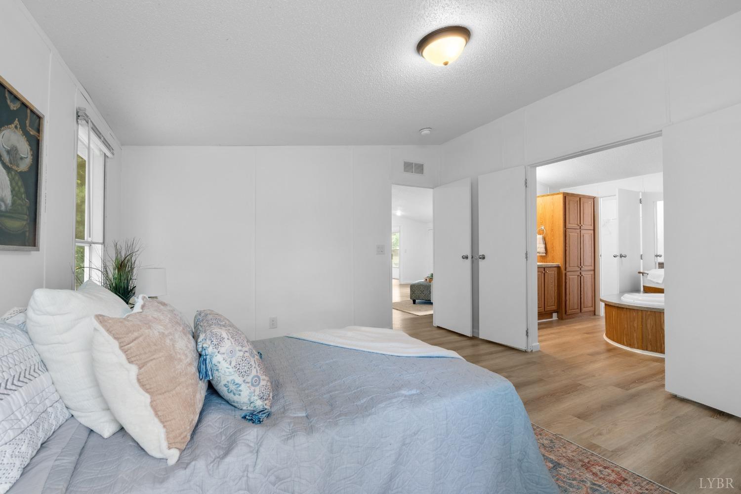 128 Douglas Drive Dry Fork, VA 24549 - Photo 21 of 45 a spacious bedroom with a bed and a couch