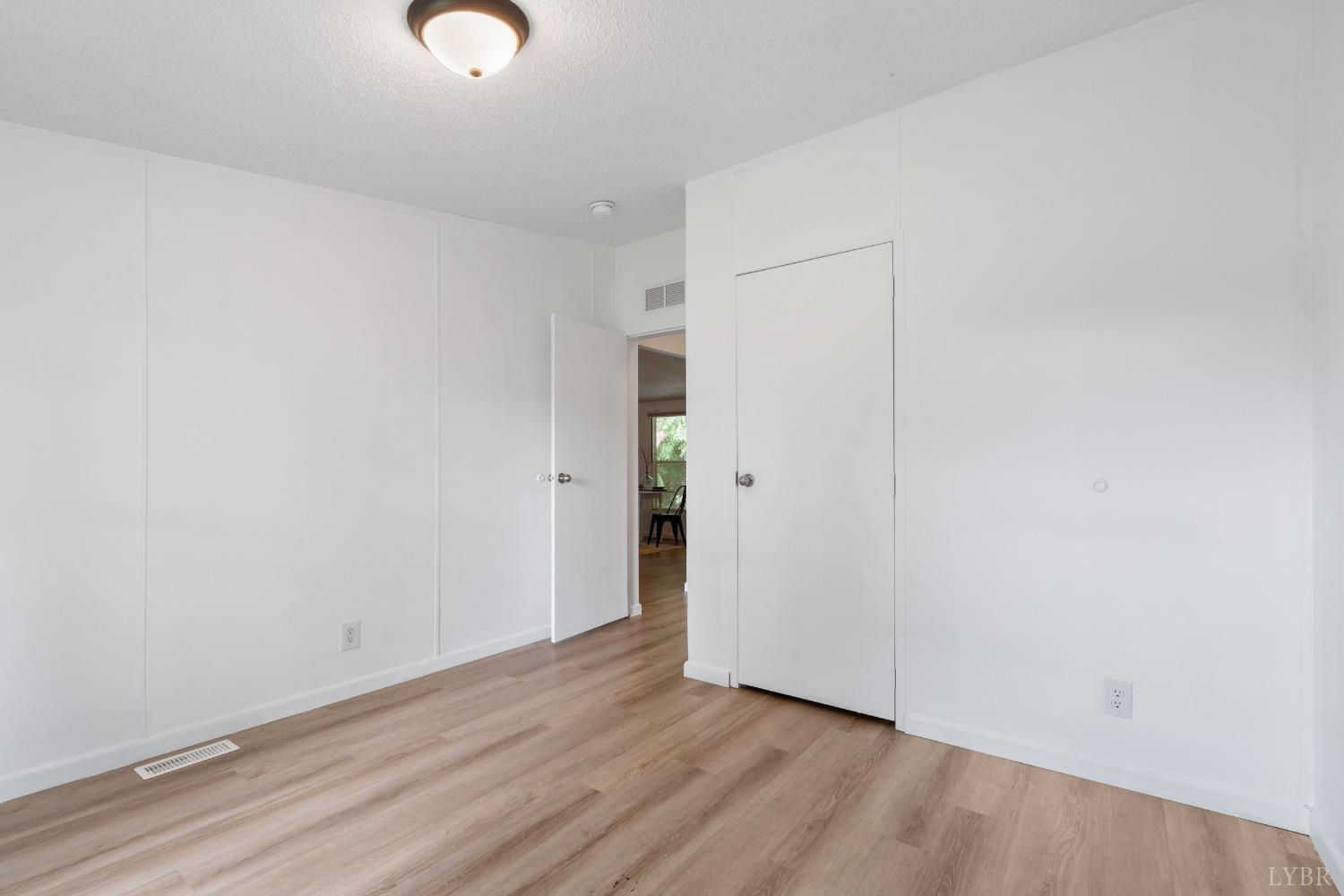 128 Douglas Drive Dry Fork, VA 24549 - Photo 30 of 45 a view of an empty room with wooden floor