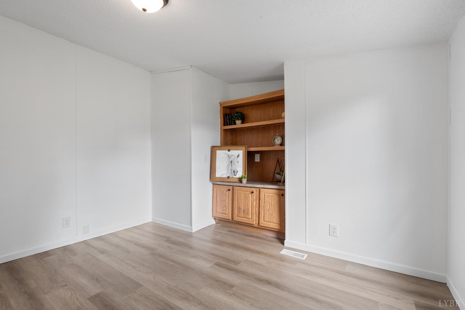 128 Douglas Drive Dry Fork, VA 24549 - Photo 8 of 45 a view of a kitchen with wooden floor and a sink