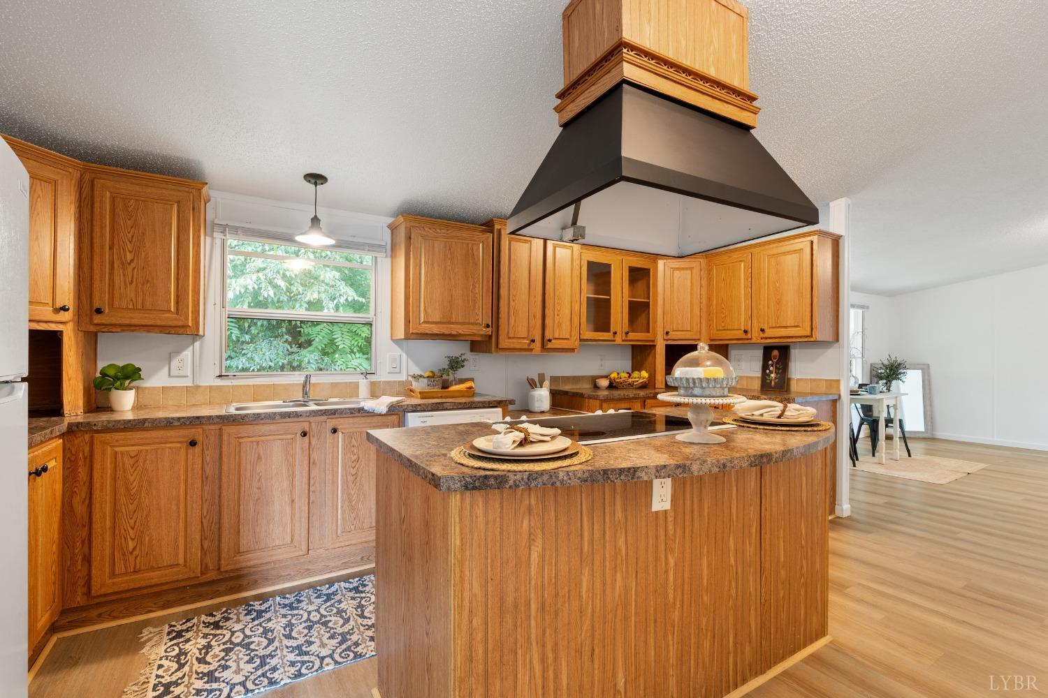 128 Douglas Drive Dry Fork, VA 24549 - Photo 10 of 45 a kitchen with stainless steel appliances granite countertop a stove a sink dishwasher and cabinets with wooden floor