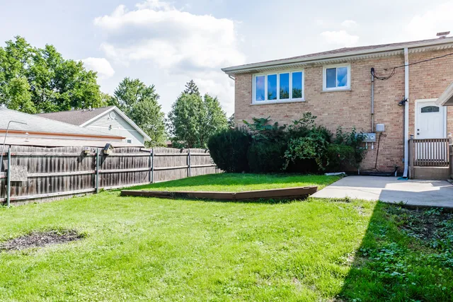 a view of a house with a yard and sitting area
