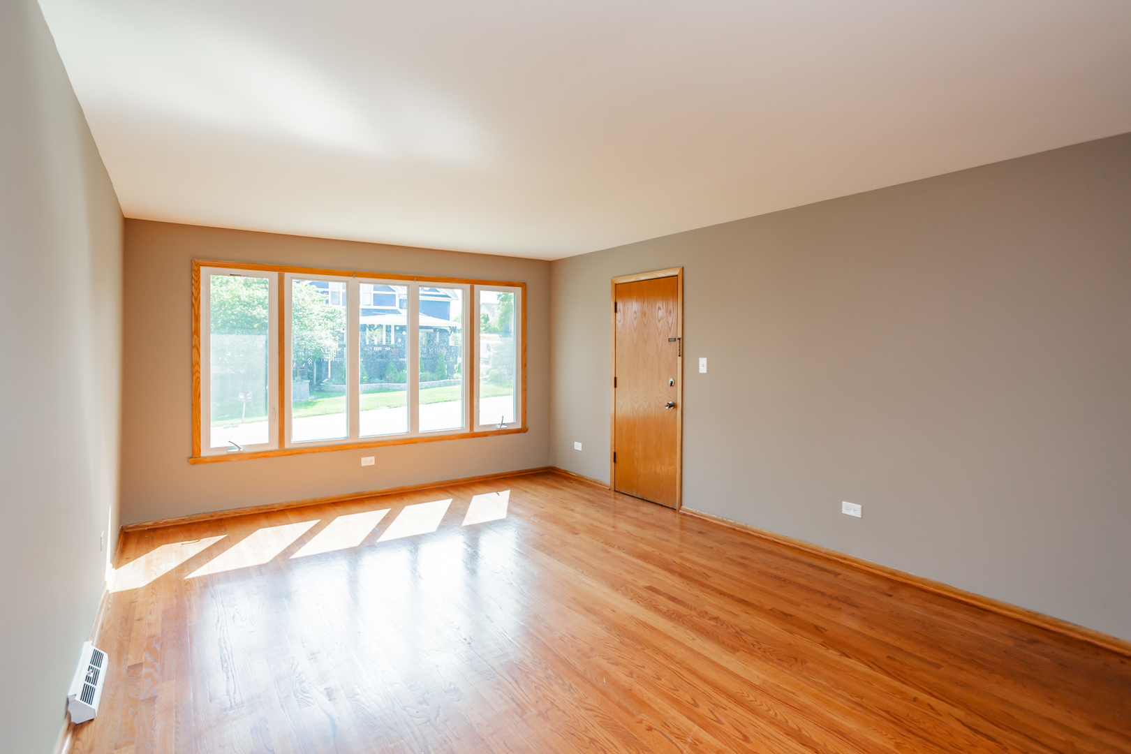7840 Cronin Avenue, Unit 2 Justice, IL 60458 - Photo 7 of 20 a view of an empty room with wooden floor and a window