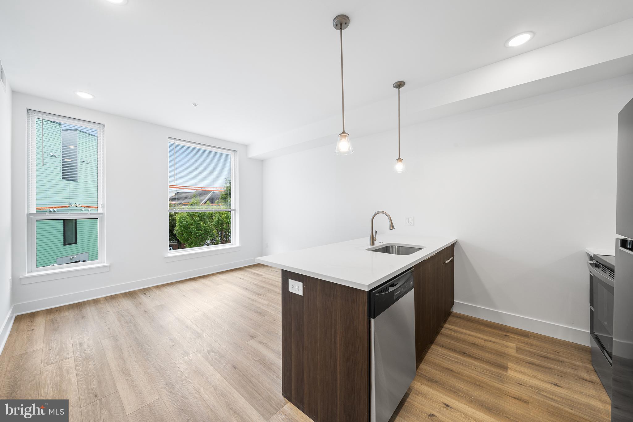 4324 Lancaster Avenue, Unit 100 Philadelphia, PA 19104 - Photo 11 of 19 a kitchen with a sink a window and wooden floor
