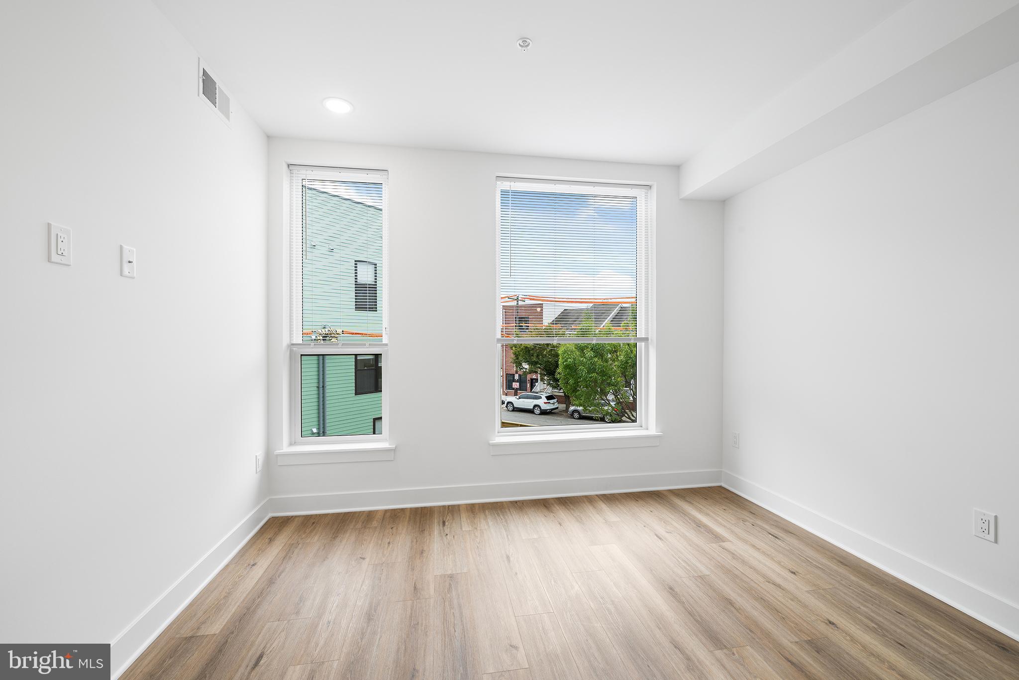 4324 Lancaster Avenue, Unit 100 Philadelphia, PA 19104 - Photo 13 of 19 an empty room with wooden floor and windows