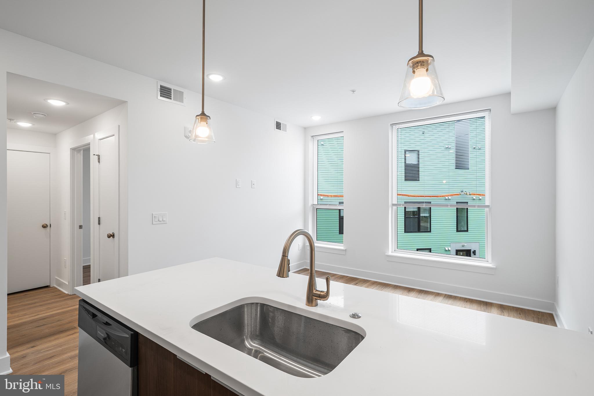 4324 Lancaster Avenue, Unit 100 Philadelphia, PA 19104 - Photo 16 of 19 a kitchen with a sink a counter top space and a view of kitchen