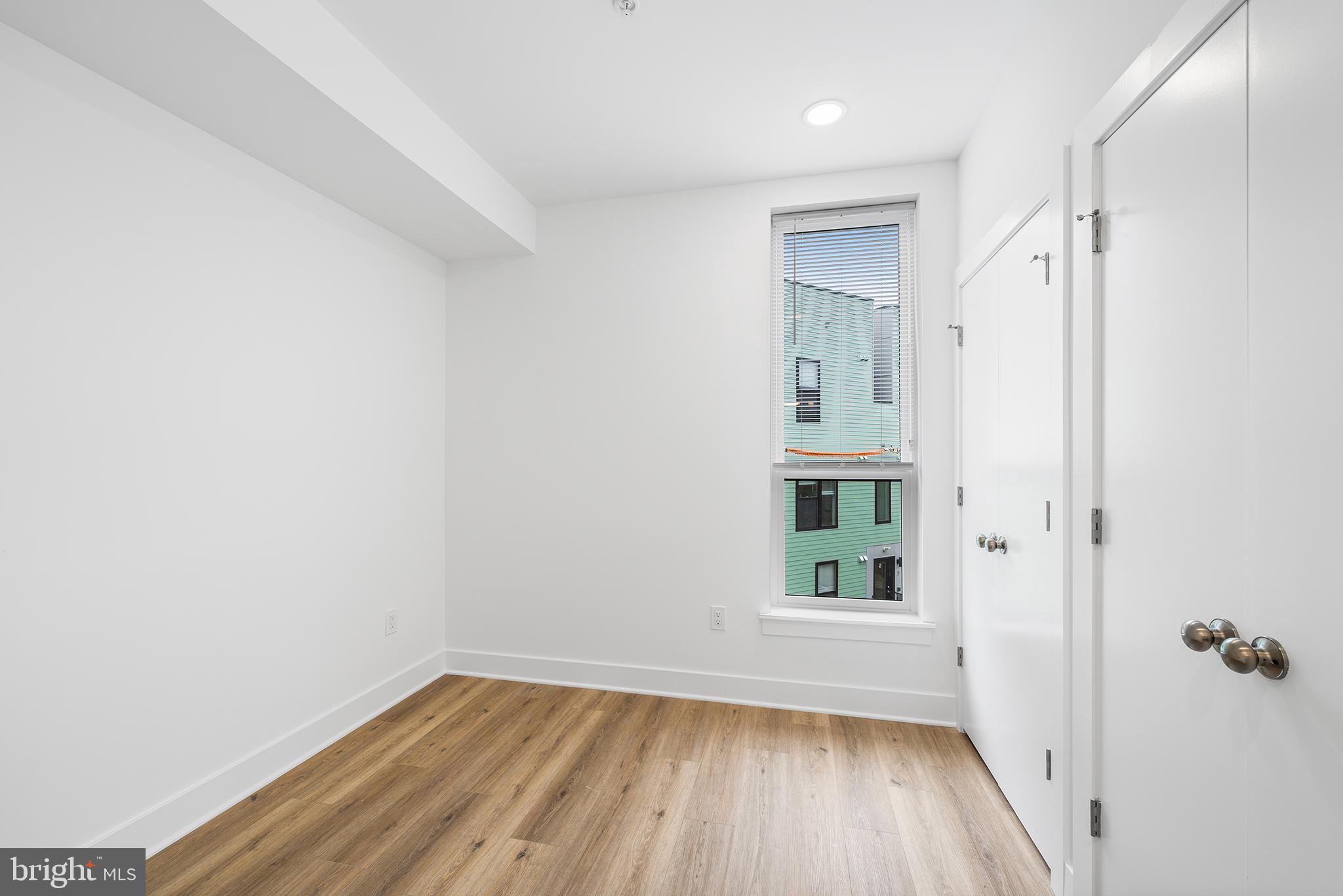 4324 Lancaster Avenue, Unit 100 Philadelphia, PA 19104 - Photo 18 of 19 a view of an empty room with wooden floor and a window