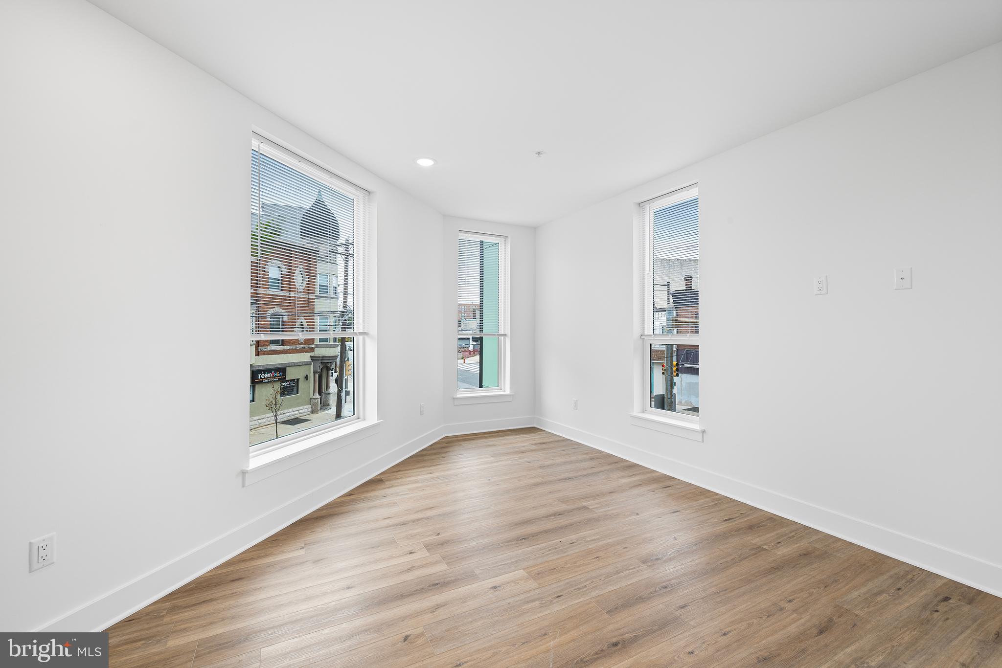 4324 Lancaster Avenue, Unit 100 Philadelphia, PA 19104 - Photo 7 of 19 an empty room with wooden floor and windows
