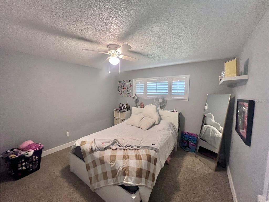 357 Tymber Run Ormond Beach, FL 32174 - Photo 24 of 32 a bedroom with bed and window