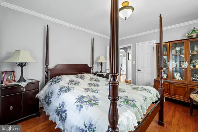 a bedroom with a bed window and lamp