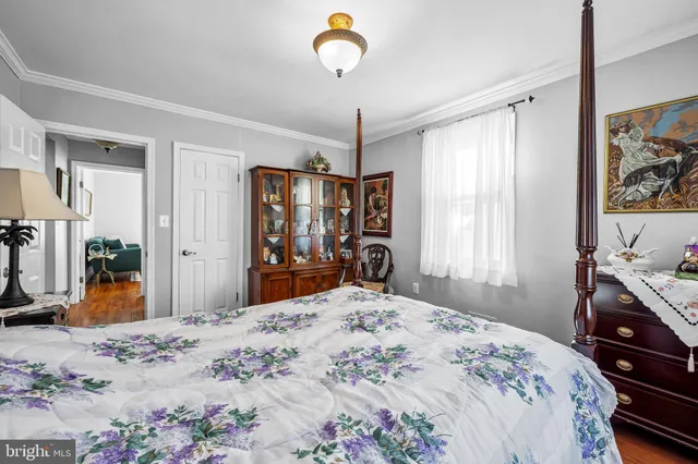 a bedroom with a bed and a dresser in it