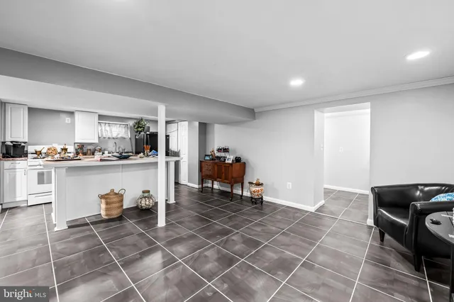 a kitchen with granite countertop a stove a sink and a refrigerator