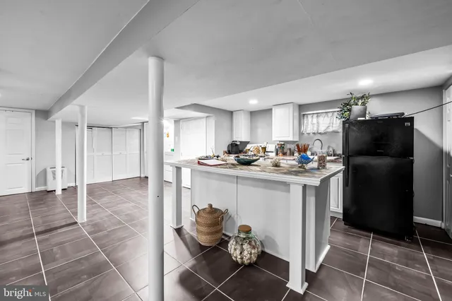 a kitchen with refrigerator and cabinets