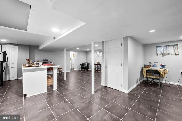 a room with a washing machine and a view of dining table
