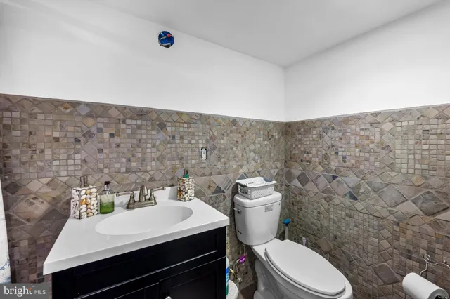 a bathroom with a sink a toilet and mirror