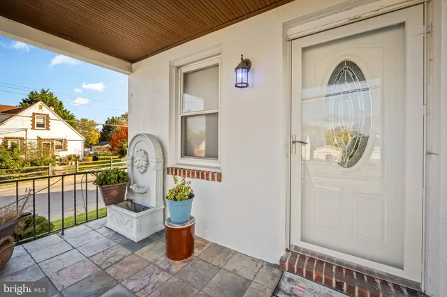 a front view of a house with outdoor seating