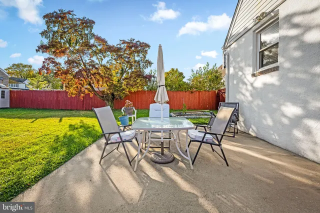 a view of a chairs and table in backyard of the house