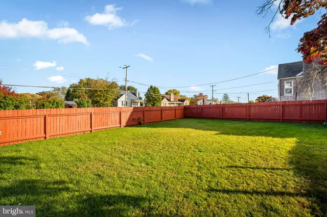 a view of yard with swimming pool and green space