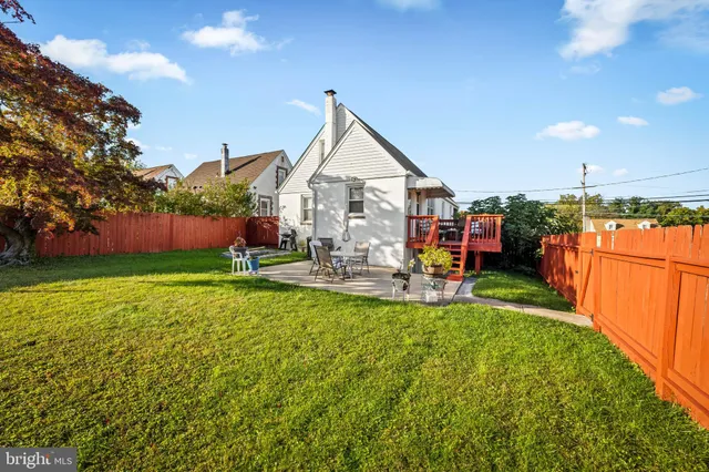 a view of a house with backyard porch and sitting area