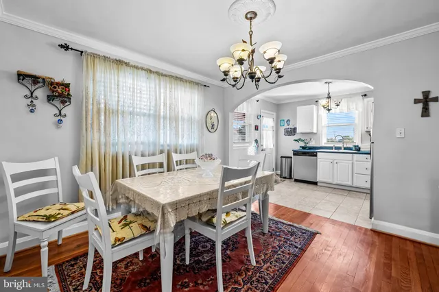 a view of a dining room with furniture and chandelier