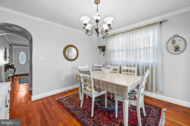 a view of a room with furniture wooden floor and a clock