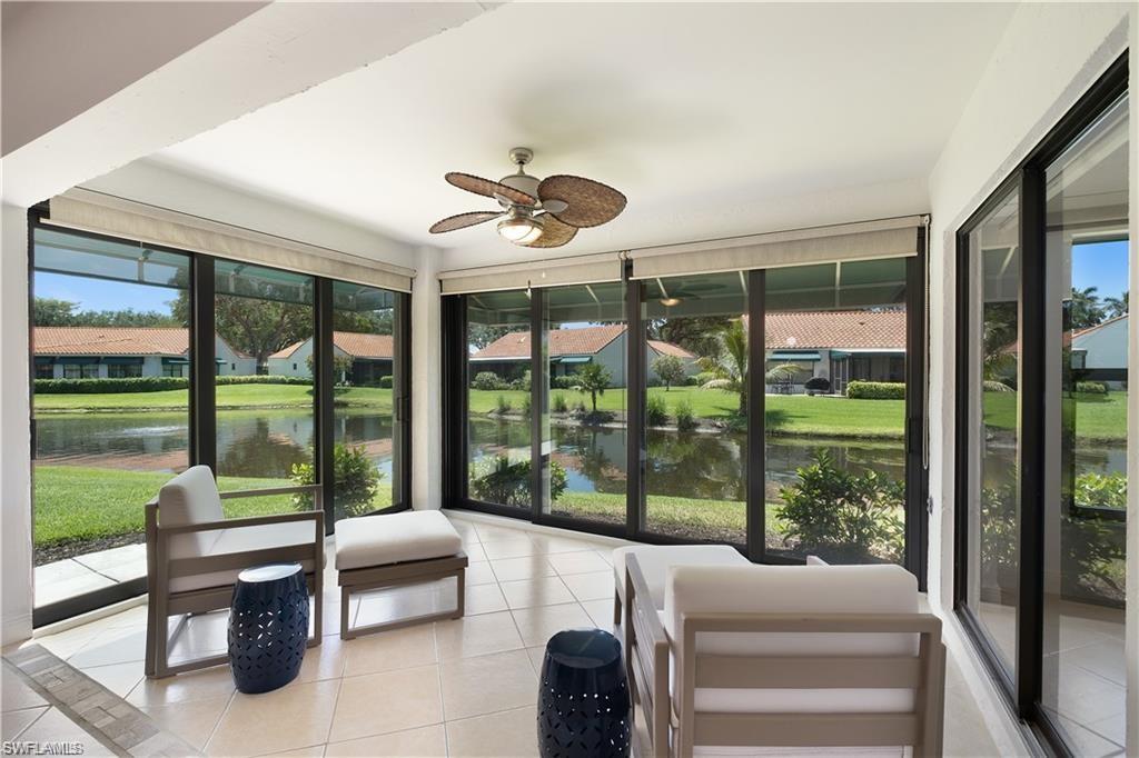 845 Reef Point Circle Naples, FL 34108 - Photo 12 of 41 a bedroom with furniture and large windows