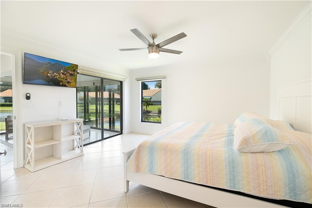 845 Reef Point Circle Naples, FL 34108 - Photo 15 of 41 a bedroom with a bed and a large window