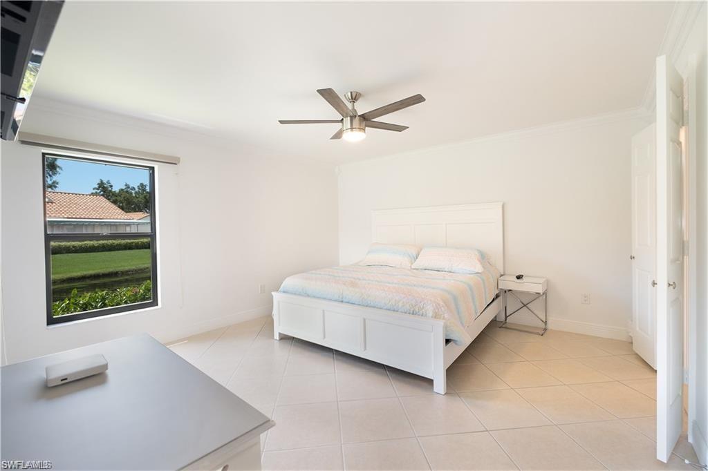 845 Reef Point Circle Naples, FL 34108 - Photo 16 of 41 a bedroom with a bed and a window
