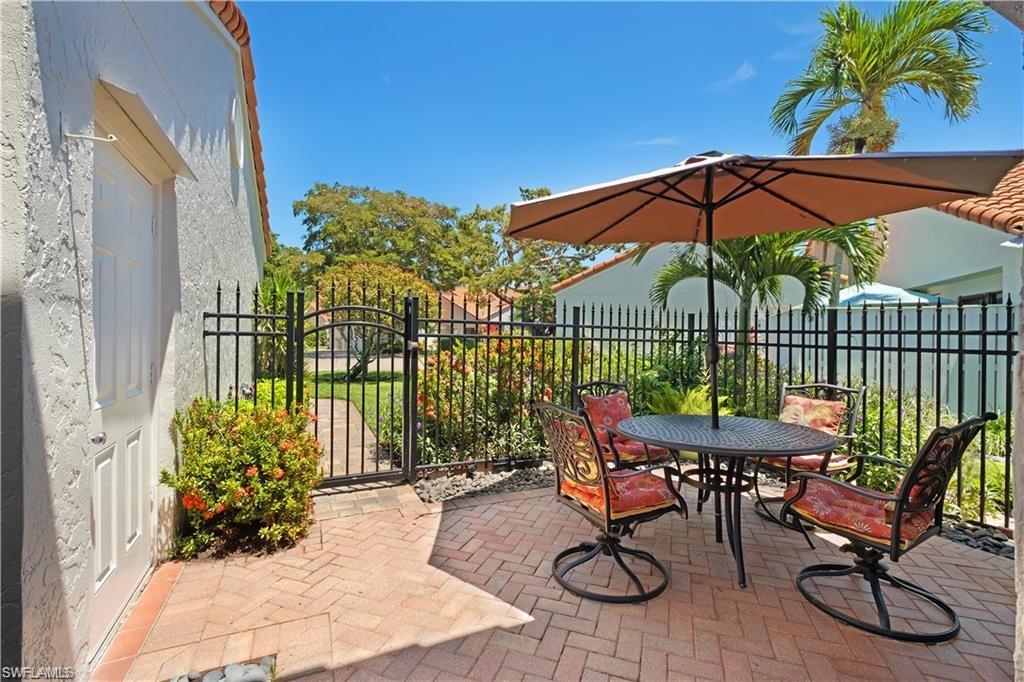 845 Reef Point Circle Naples, FL 34108 - Photo 25 of 41 a view of a chairs and table in backyard