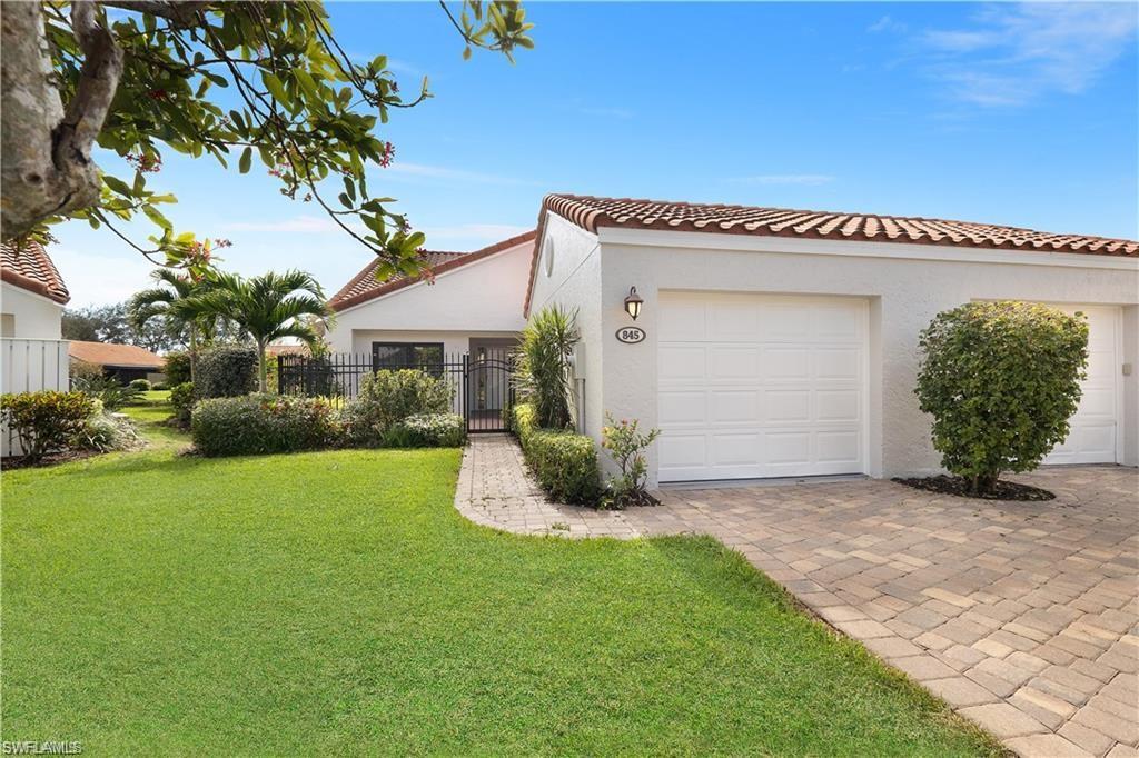 845 Reef Point Circle Naples, FL 34108 - Photo 26 of 41 a view of a house with a garden