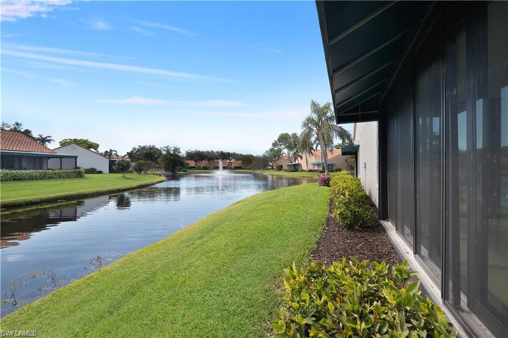 845 Reef Point Circle Naples, FL 34108 - Photo 30 of 41 a view of a lake with a house in the background