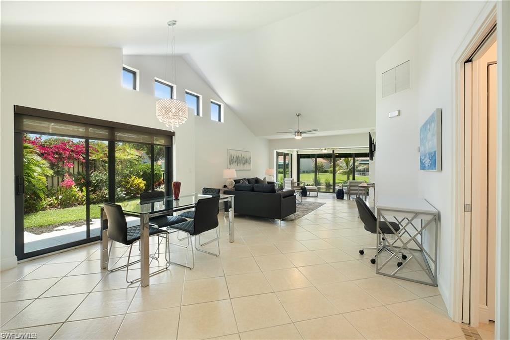 845 Reef Point Circle Naples, FL 34108 - Photo 3 of 41 a living room with furniture and large windows