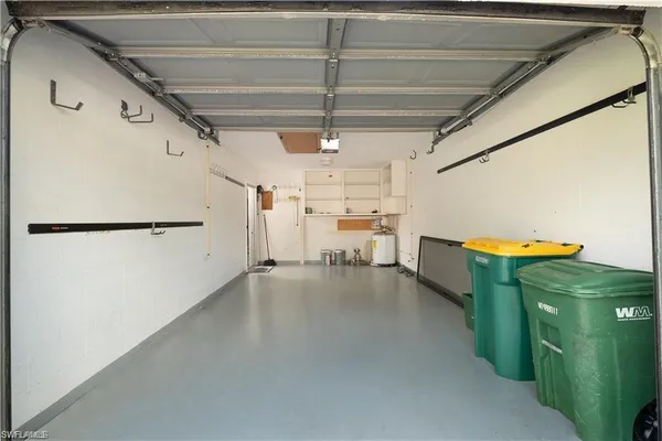 a view of storage and utility room with a fridge